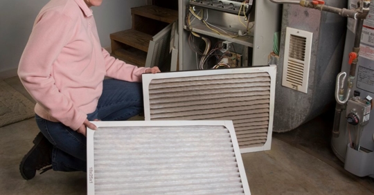 Man changing filters in furnace