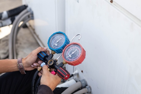 HVAC tech performing a maintenance check